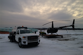Company Training at L R Helicopters. - a truck and a helicopter standing side by side
