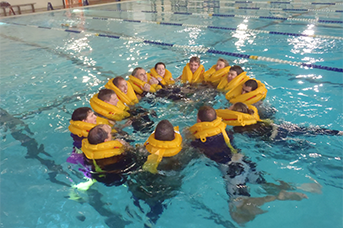 Initial-and-annual Helicopter Training. Students in a pool