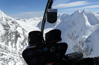 Avalanche Control - Helicopter flying over a mountain