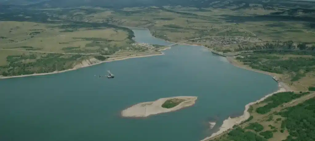 Aerial view of an L R Helicopters aircraft flying over the Bow River and town of Cochrane, Alberta on the Cochrane Scenic Tour