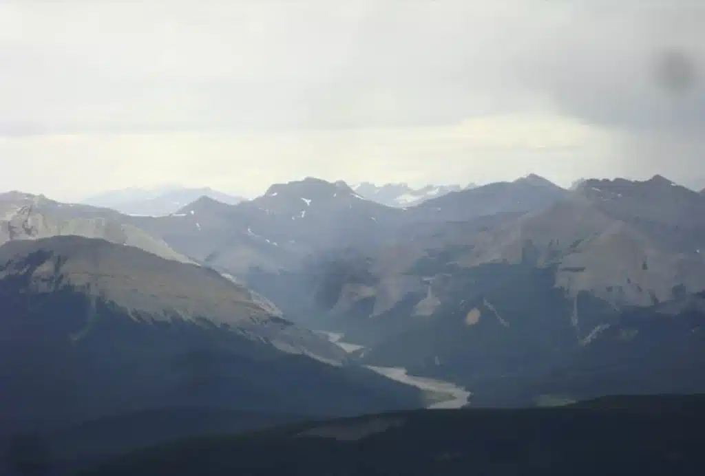 Aerial view of the Elbow River valley and Rocky Mountain ridges on the Elbow Falls Bragg Creek Movie Site Tour with L R Helicopters