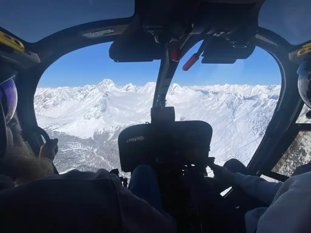 Cockpit view of snow-covered peaks and glaciers on the Haig Glacier Helicopter Tour with L R Helicopters from Calgary, Alberta