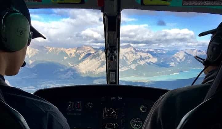 Cockpit view of Extended FAM Flight Experience with L R Helicopters over the Rocky Mountains near Calgary, Alberta